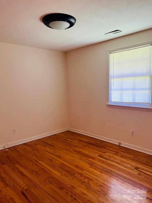3232 Wilson Heights Dr, Hildebran, NC 28637 - empty room with wood finished floors and a textured ceiling