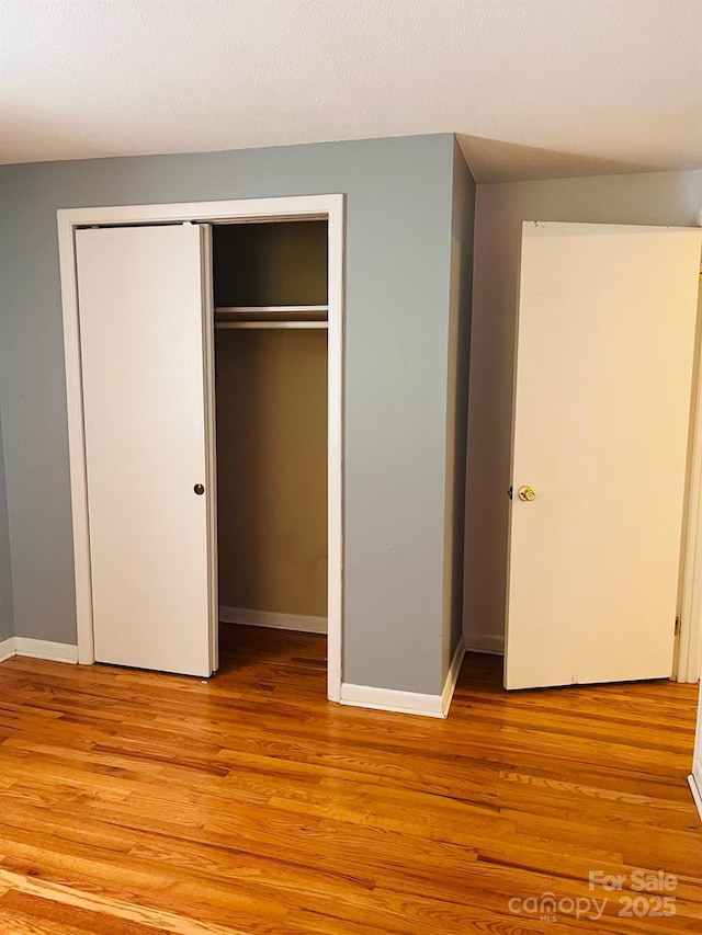 3232 Wilson Heights Dr, Hildebran, NC 28637 - unfurnished bedroom with light wood finished floors and a closet