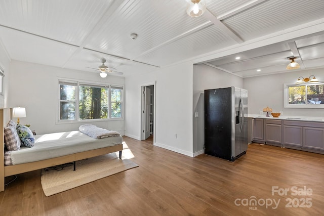 203 Davis Mountain Rd, Laurel Park, NC 28739 - bedroom with stainless steel refrigerator with ice dispenser, multiple windows, wood finished floors, beam ceiling, and recessed lighting