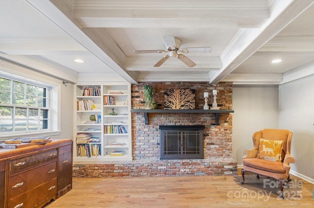 203 Davis Mountain Rd, Laurel Park, NC 28739 - living room featuring wood finished floors, beamed ceiling, crown molding, a brick fireplace, and ceiling fan