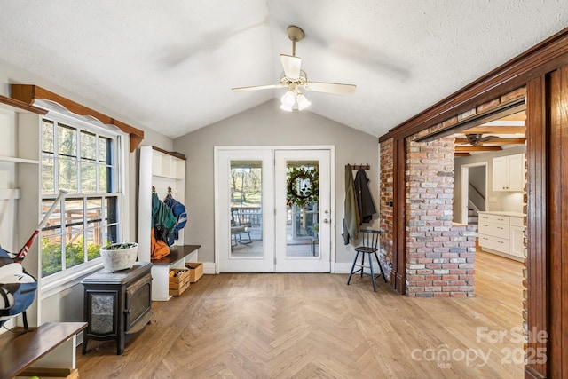 203 Davis Mountain Rd, Laurel Park, NC 28739 - foyer entrance featuring ceiling fan, vaulted ceiling, and a wood stove