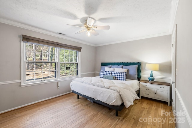 203 Davis Mountain Rd, Laurel Park, NC 28739 - bedroom featuring light wood-style flooring, crown molding, a textured ceiling, and ceiling fan