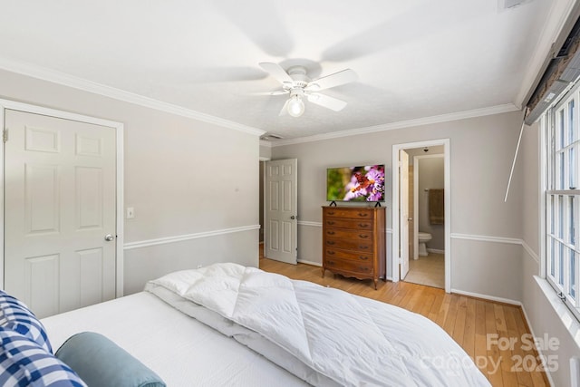 203 Davis Mountain Rd, Laurel Park, NC 28739 - bedroom featuring light wood-type flooring, ornamental molding, a ceiling fan, and ensuite bathroom