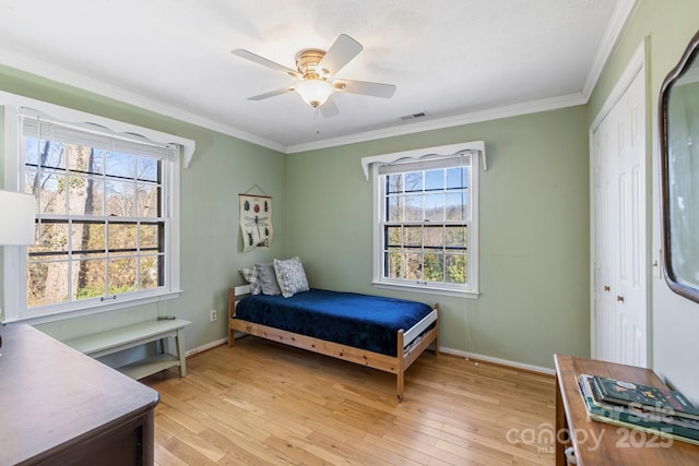 203 Davis Mountain Rd, Laurel Park, NC 28739 - bedroom featuring ornamental molding, light wood-style floors, ceiling fan, and a closet