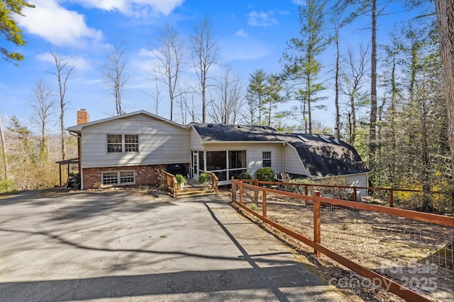 203 Davis Mountain Rd, Laurel Park, NC 28739 - view of front facade with driveway, a chimney, and brick siding
