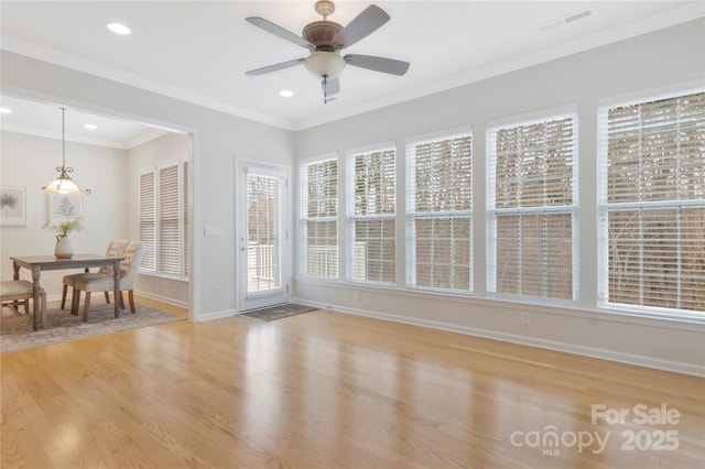 sunroom / solarium with recessed lighting, visible vents, baseboards, and wood finished floors