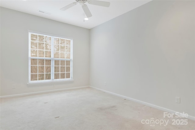 unfurnished room with visible vents, baseboards, and light carpet