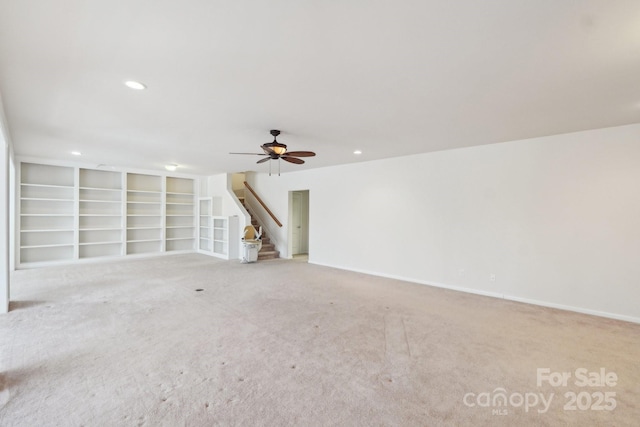 unfurnished living room with stairway, a ceiling fan, carpet flooring, and recessed lighting