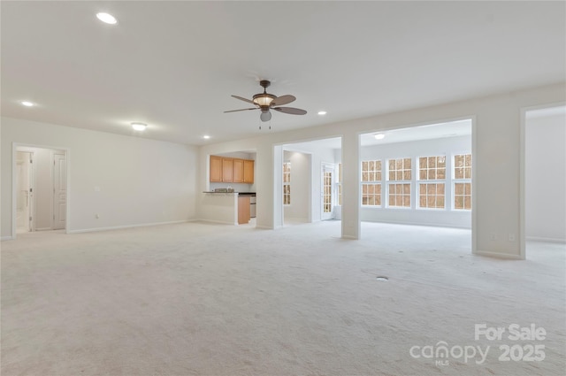 unfurnished living room featuring light colored carpet, ceiling fan, baseboards, and recessed lighting