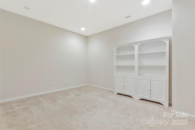 carpeted spare room featuring visible vents, baseboards, and recessed lighting