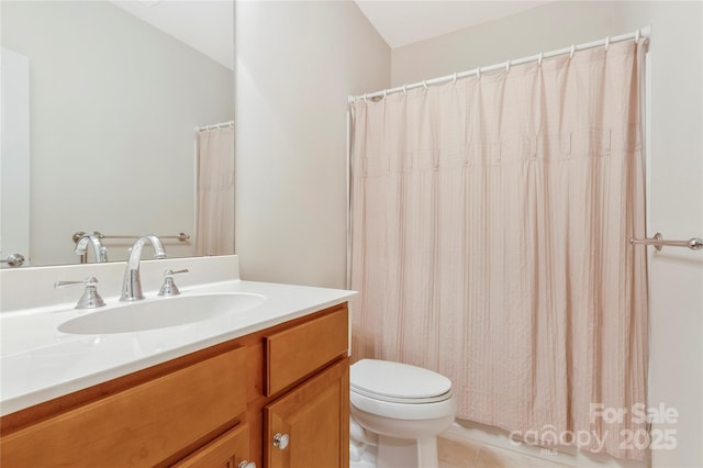 bathroom with tile patterned floors, vanity, and toilet
