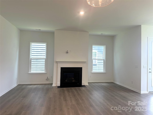324 Basil Dr, Indian Trail, NC 28079 - unfurnished living room with dark wood-type flooring and a fireplace with flush hearth
