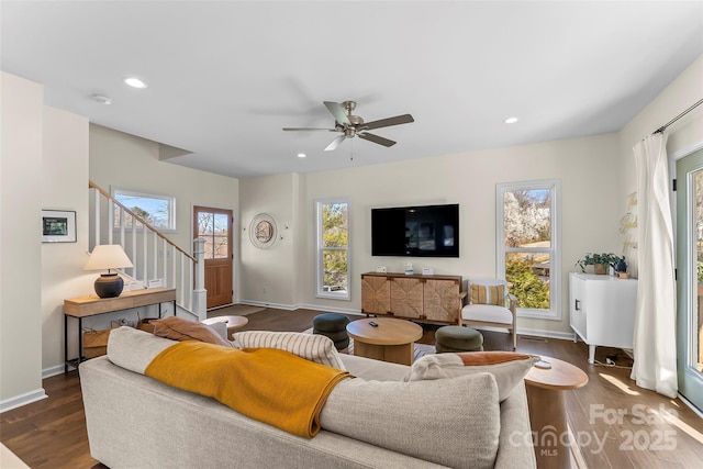 living area with dark wood finished floors, recessed lighting, stairs, and baseboards