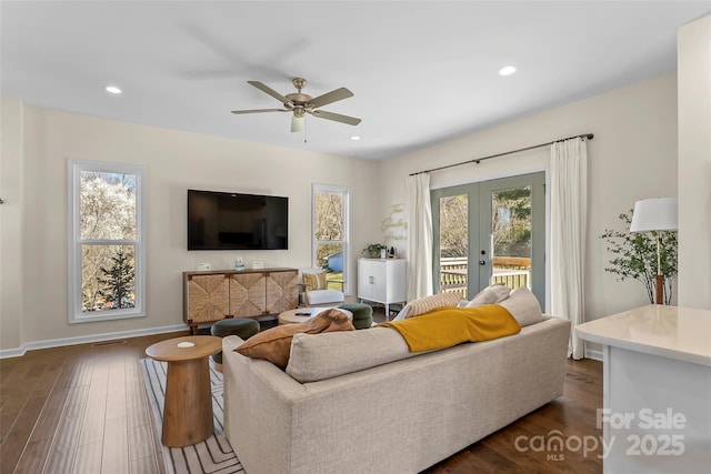 living room featuring dark wood-type flooring, baseboards, ceiling fan, recessed lighting, and french doors