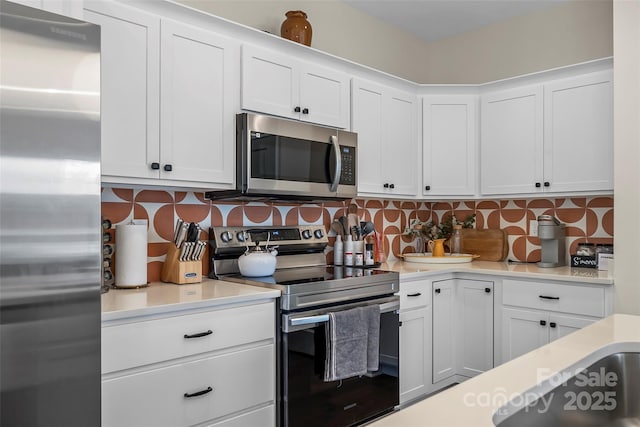 kitchen featuring white cabinetry, light countertops, and stainless steel appliances