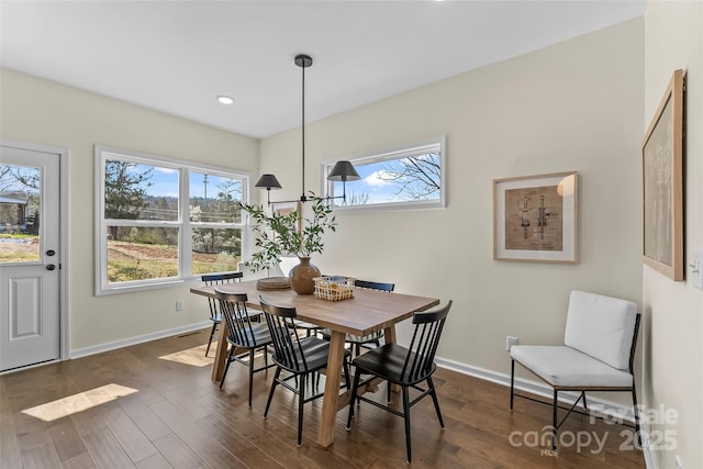 dining room with a healthy amount of sunlight, baseboards, and dark wood-style flooring