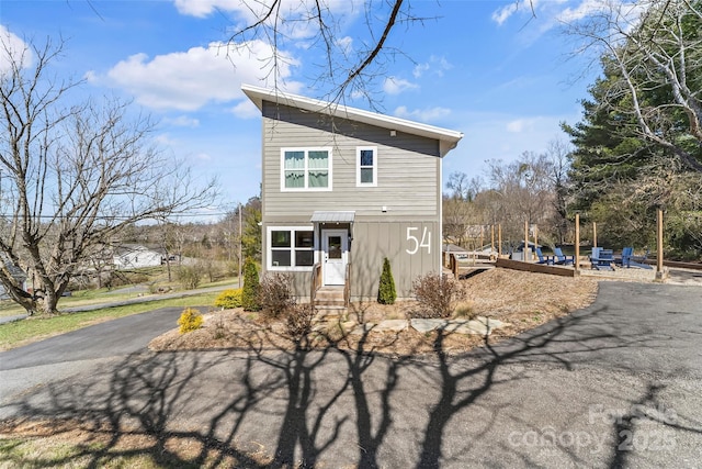 view of front of home with aphalt driveway and entry steps