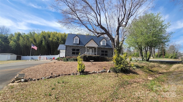 view of front of home featuring metal roof and stone siding