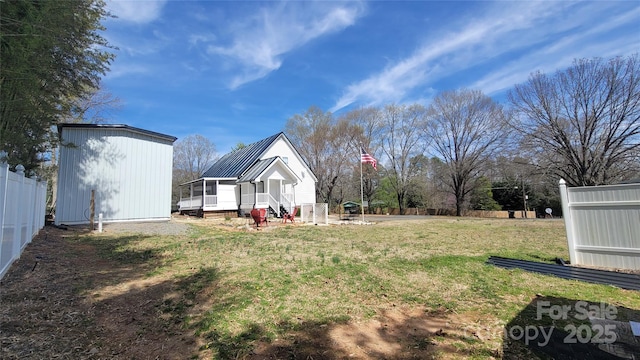 view of yard featuring an outbuilding and fence