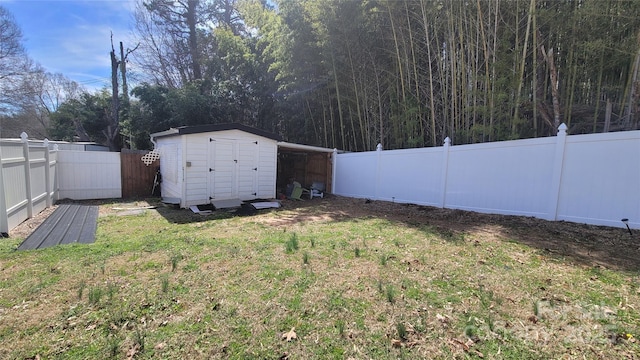 view of yard with an outbuilding, a storage unit, and a fenced backyard