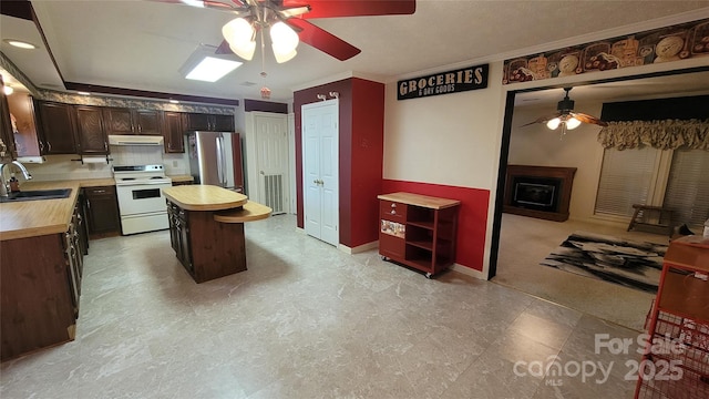 kitchen featuring a ceiling fan, range hood, white electric range oven, freestanding refrigerator, and wooden counters