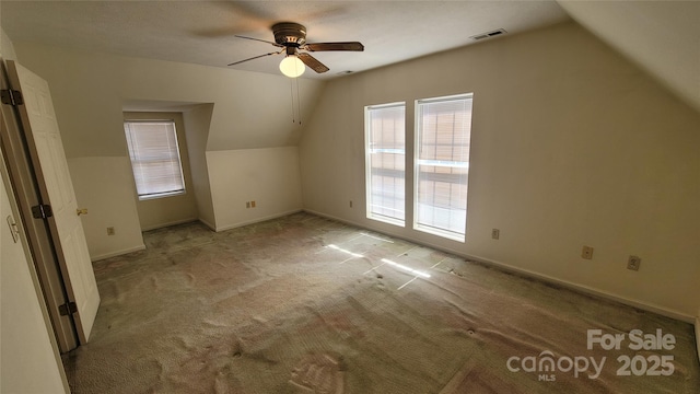 bonus room featuring visible vents, lofted ceiling, a ceiling fan, carpet floors, and baseboards