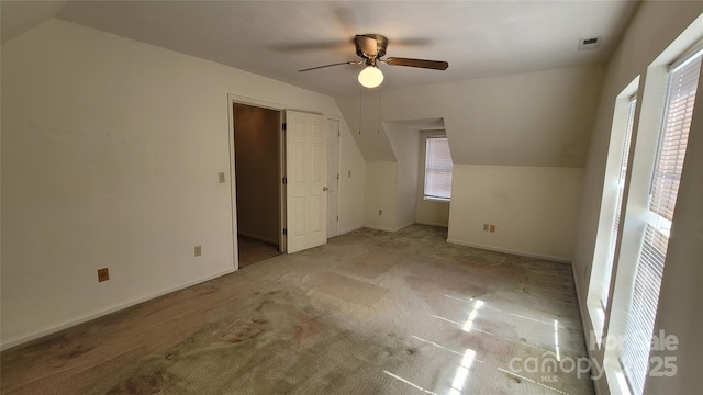 bonus room with lofted ceiling, baseboards, carpet, and ceiling fan
