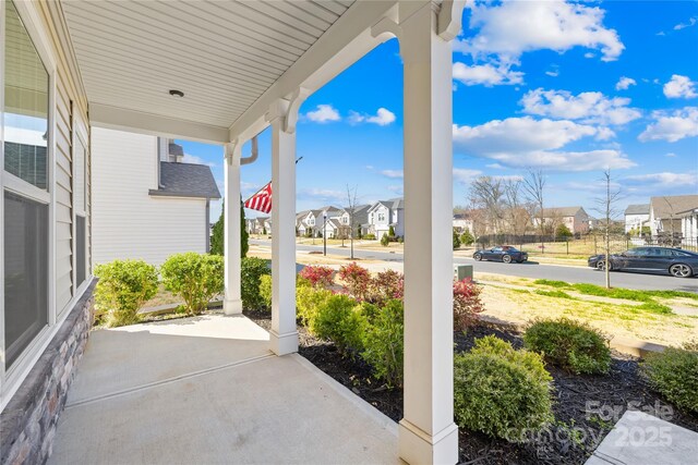 view of patio / terrace featuring a porch and a residential view