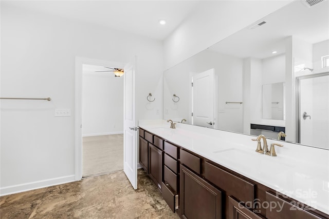 bathroom featuring baseboards, visible vents, double vanity, a sink, and a shower stall