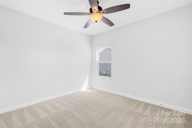 unfurnished room featuring carpet, baseboards, and ceiling fan