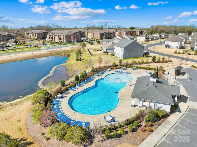 drone / aerial view featuring a residential view and a water view