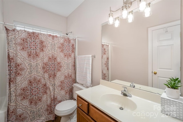 bathroom featuring toilet, vanity, and shower / tub combo