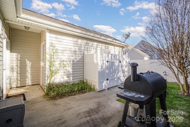 view of patio featuring grilling area and fence