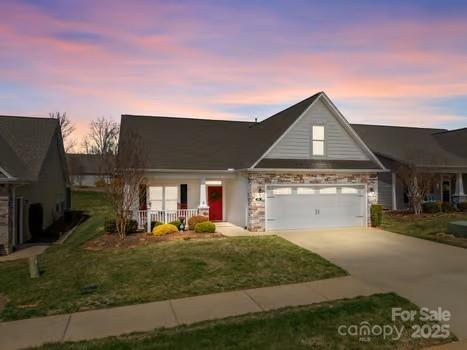 420 Spring Arbor Ave Unit 80, Salisbury, NC 28146 - view of front facade with a front yard, an attached garage, covered porch, concrete driveway, and stone siding