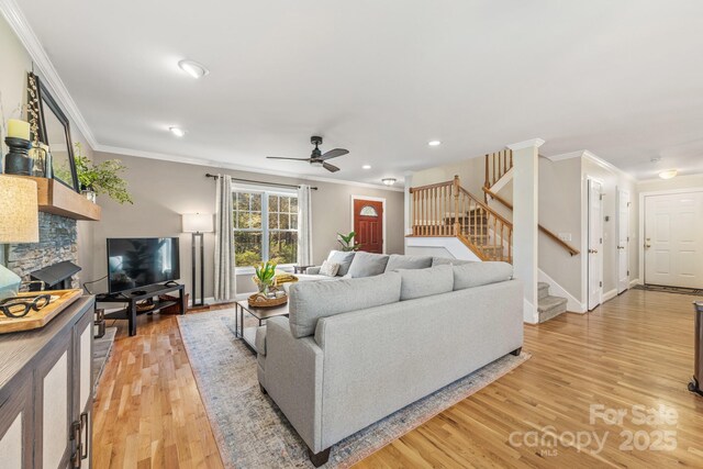 7025 Ridgeway Rd, Stanley, NC 28164 - living area with stairs, ornamental molding, light wood-style flooring, a ceiling fan, and recessed lighting