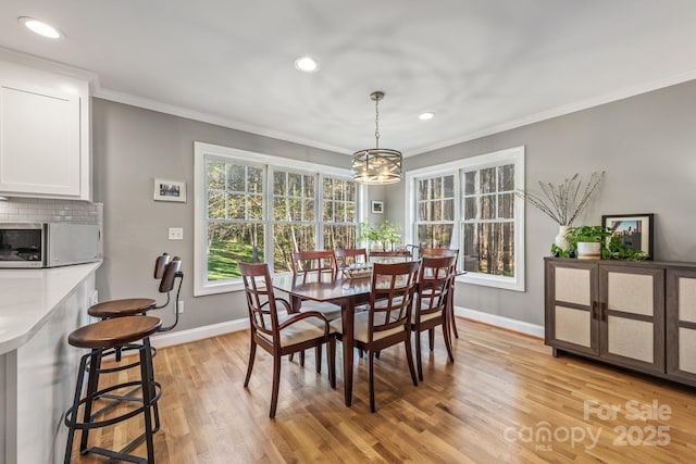 7025 Ridgeway Rd, Stanley, NC 28164 - dining room featuring light wood finished floors, a chandelier, recessed lighting, and ornamental molding