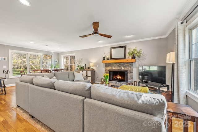 7025 Ridgeway Rd, Stanley, NC 28164 - living room featuring recessed lighting, light wood finished floors, a stone fireplace, plenty of natural light, and a ceiling fan