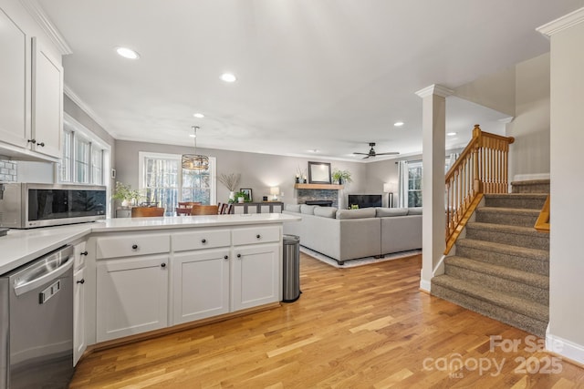 7025 Ridgeway Rd, Stanley, NC 28164 - kitchen featuring appliances with stainless steel finishes, a ceiling fan, recessed lighting, a peninsula, and a fireplace