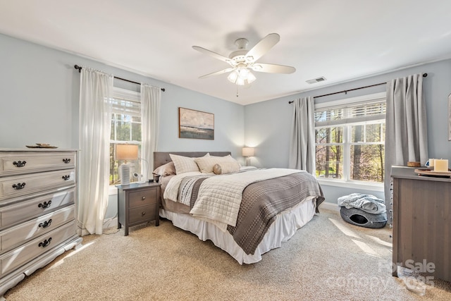 7025 Ridgeway Rd, Stanley, NC 28164 - bedroom with multiple windows, light colored carpet, and ceiling fan