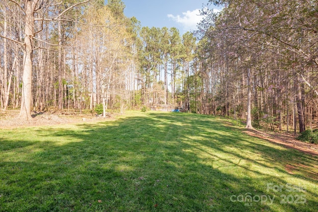 7025 Ridgeway Rd, Stanley, NC 28164 - view of grassy yard featuring a forest view