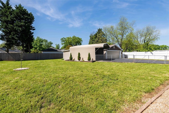 view of yard with a garage and fence