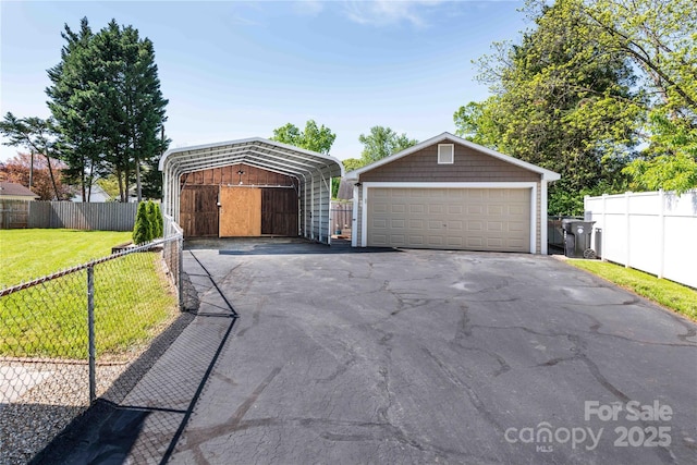 garage with fence and a carport