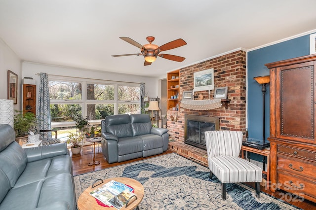 1041 Cutler Pl, Charlotte, NC 28212 - living room featuring a fireplace, wood finished floors, ornamental molding, and a ceiling fan
