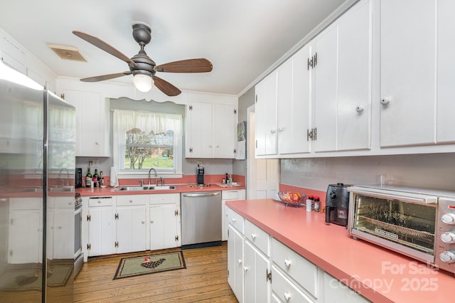 1041 Cutler Pl, Charlotte, NC 28212 - kitchen featuring white cabinetry, stainless steel appliances, a sink, light wood finished floors, and visible vents
