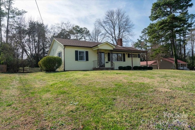 single story home featuring a chimney and a front lawn