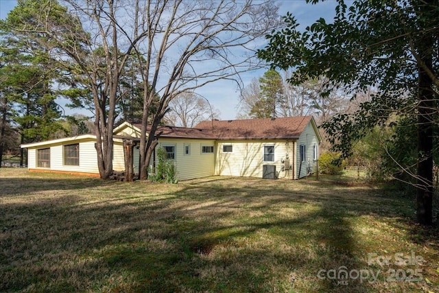 back of house with a lawn