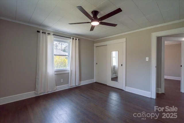 interior space featuring baseboards, wood finished floors, ceiling fan, and crown molding
