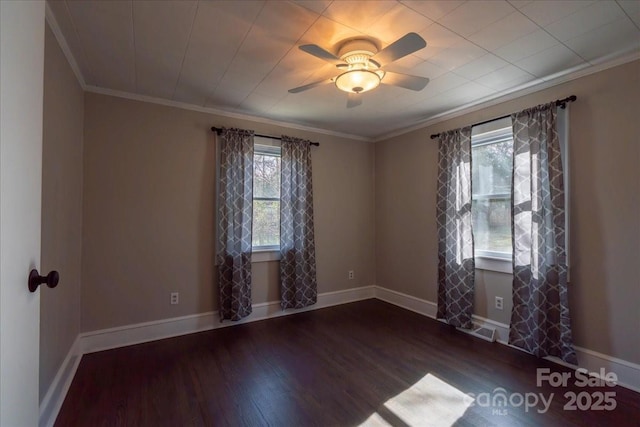 unfurnished room featuring plenty of natural light, wood finished floors, visible vents, and ornamental molding