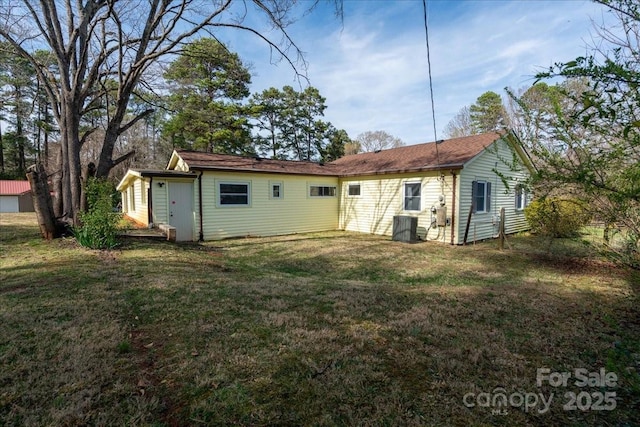 rear view of house with a lawn