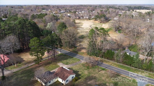 birds eye view of property featuring a wooded view